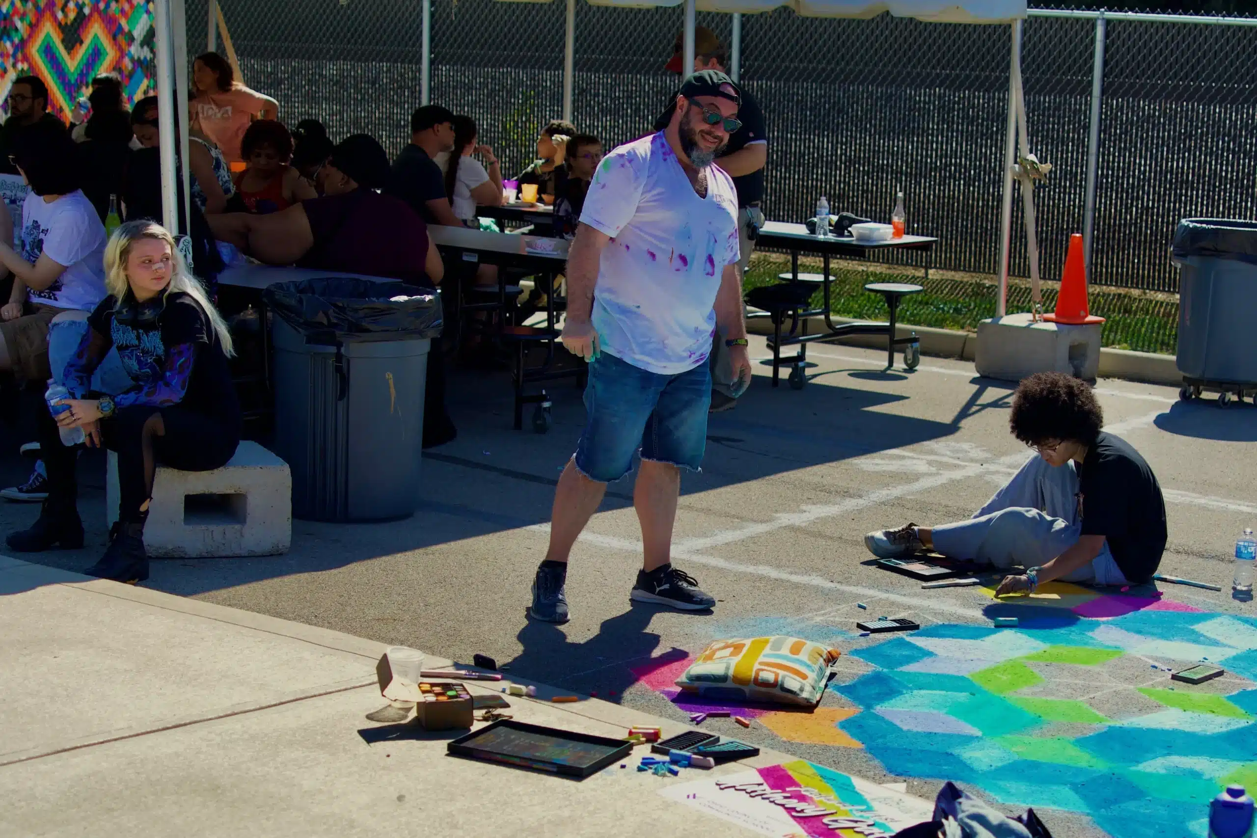 People creating chalk art on the street